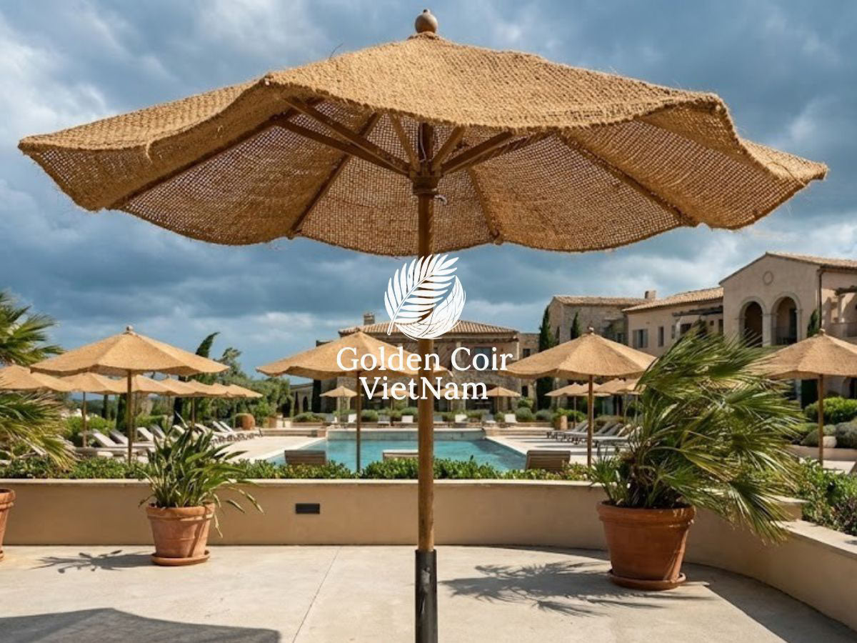 Fixed coir parasol with solid pole at a windy resort poolside demonstrating high wind frame stability