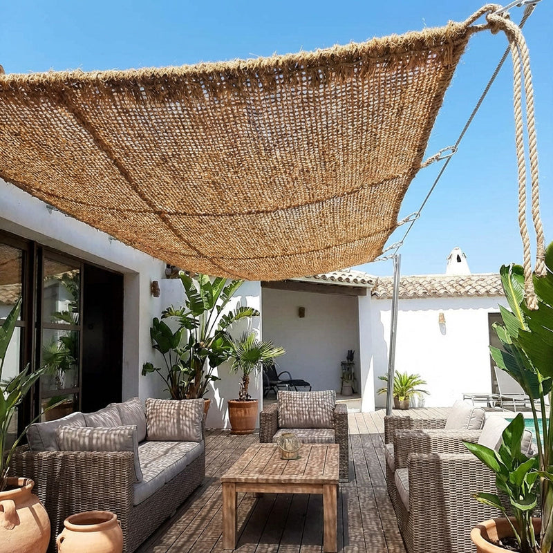 natural woven coir shade sail over outdoor patio seating area
