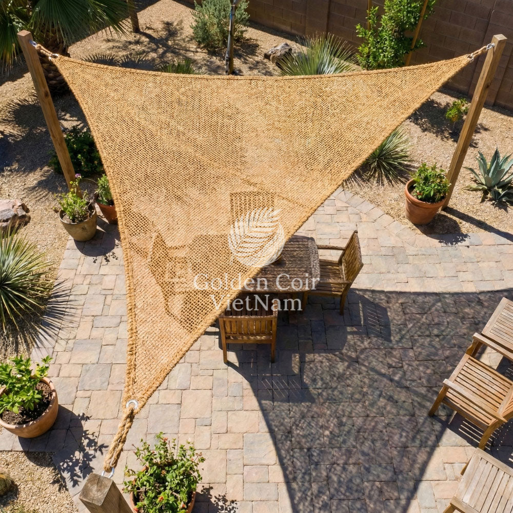 Pre made shade sails installed in a simple triangular layout for a backyard patio