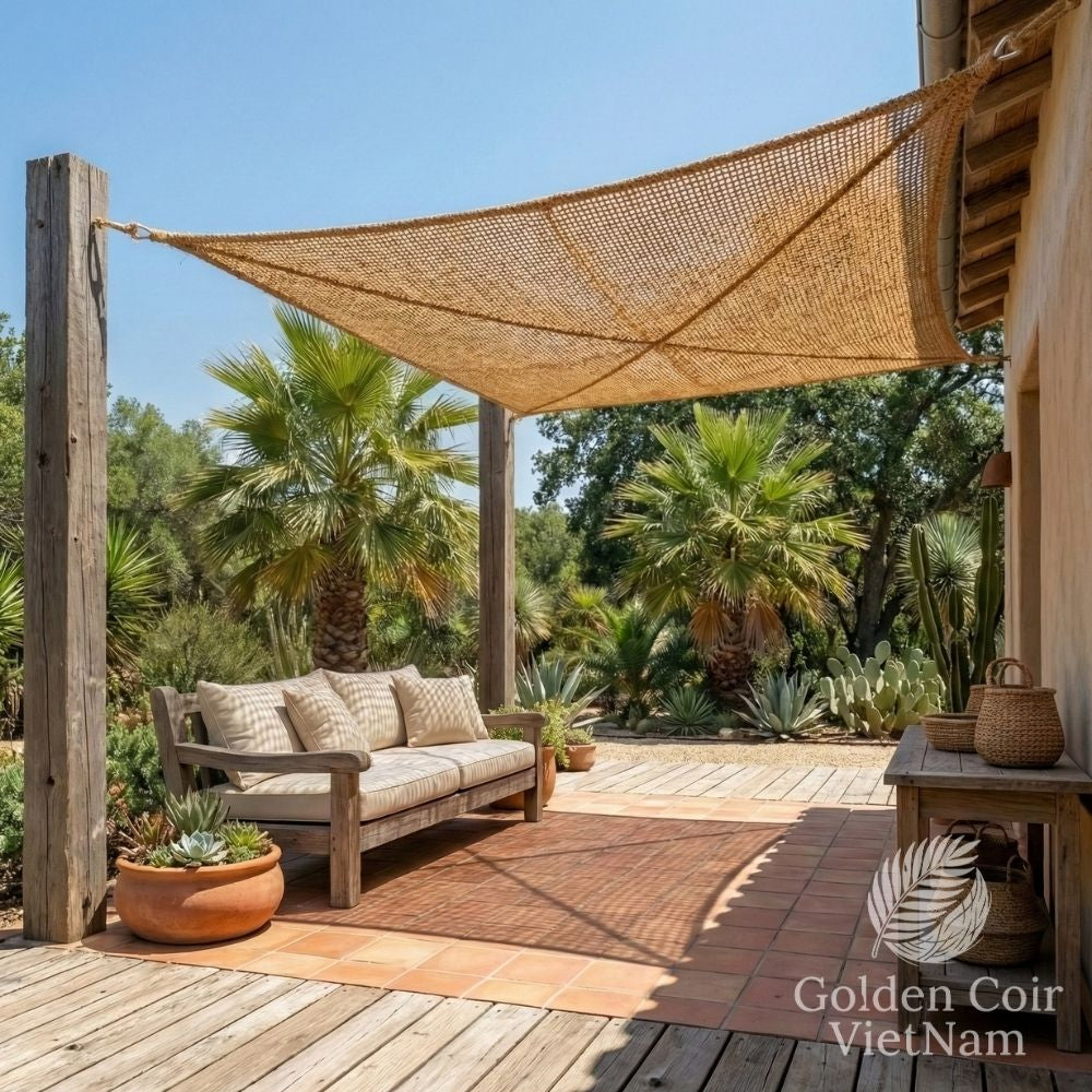 Weave coir shade sail installed in a climate responsive backyard patio system
