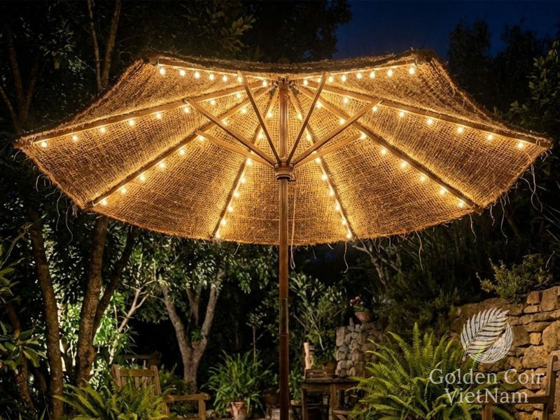 Warm white solar umbrella lights creating a cozy golden glow under a patio parasol at night